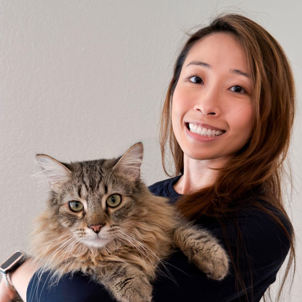 yuen chan dvm smiling holding fluffy brown cat